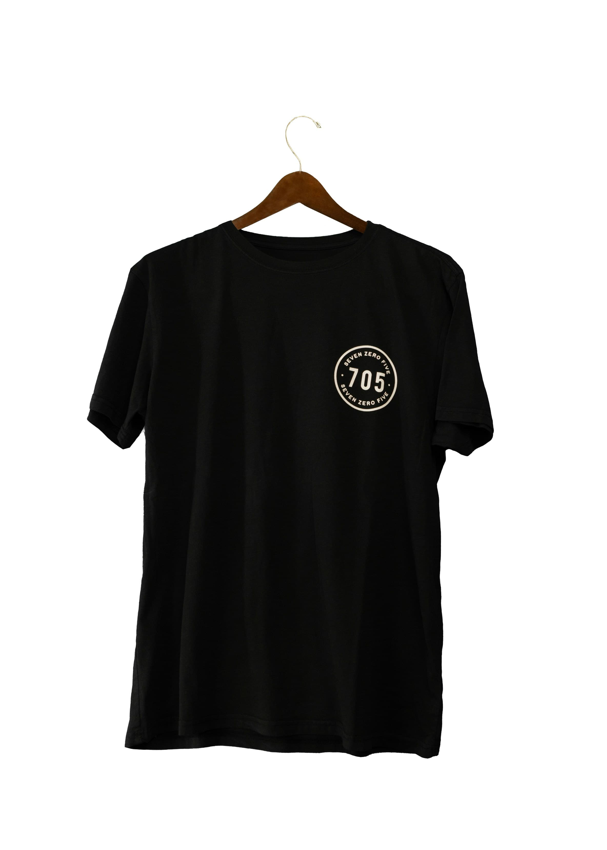 Black T-shirt on a wooden hanger against a white background